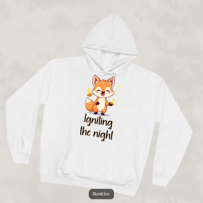 Funny fox hoodie showing a grinning fox skillfully juggling bright, glowing diyas, emanating warmth and festive cheer.